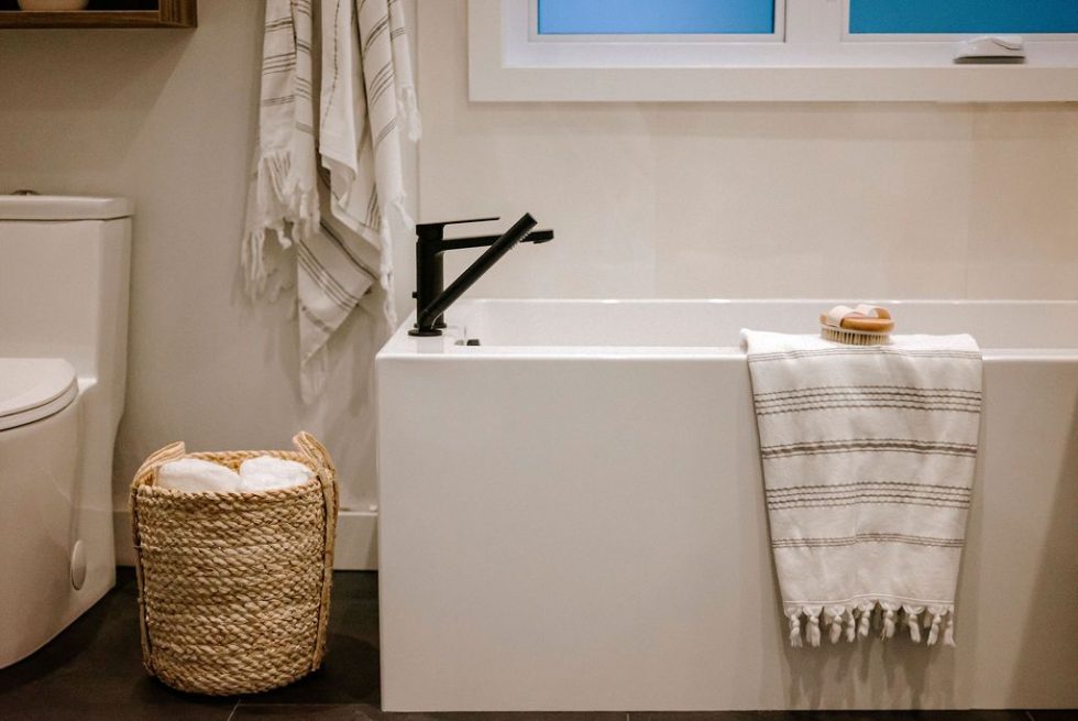 une baignoire blanche assise à côté de toilettes blanches.